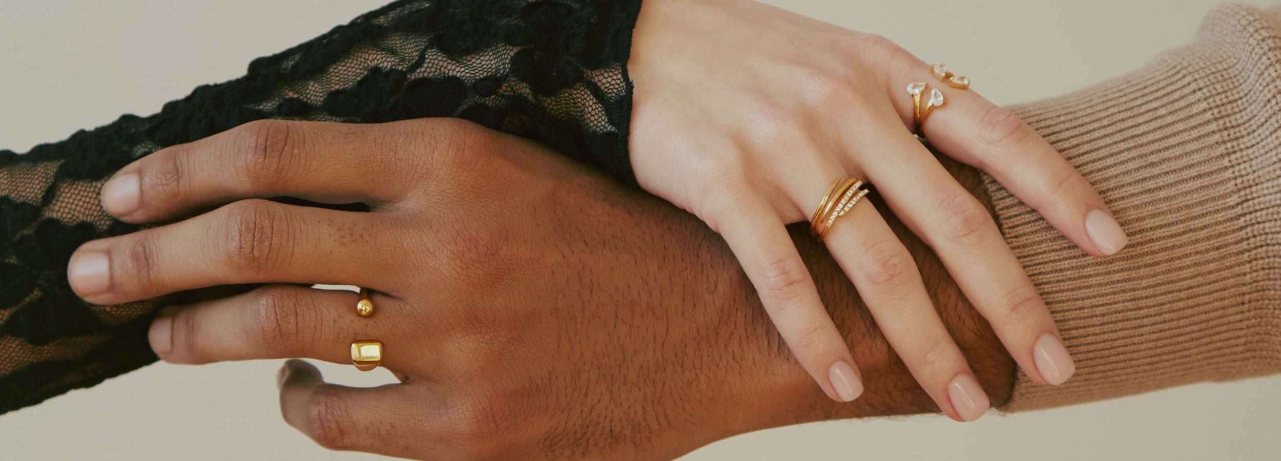 Two model hands wearing rings
