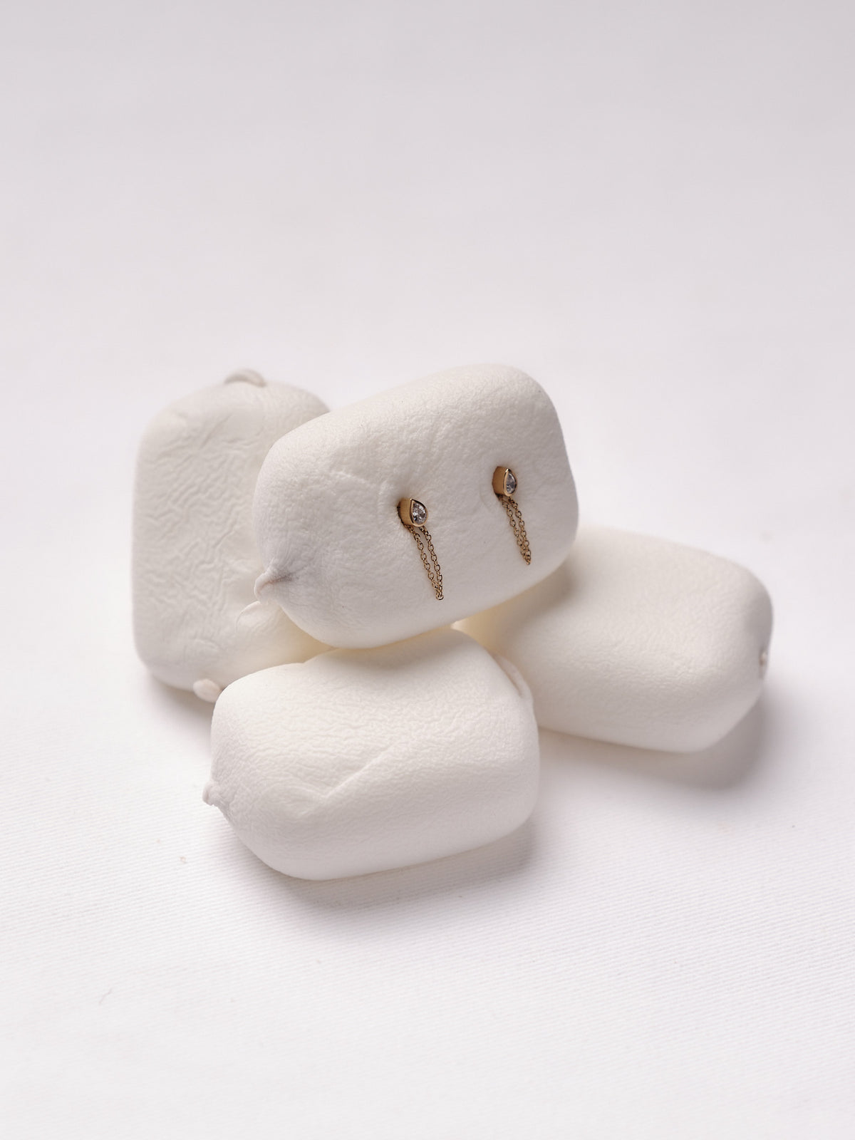 Bezel pear chain earrings on marshmallows