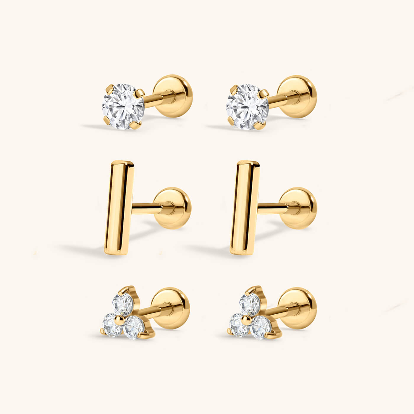 Everyday Nap Earrings Trio in titanium (gold) with Celestial Crystal Nap Earrings, Little Bar Nap Earrings and Mini Crystal Trinity Nap Earrings