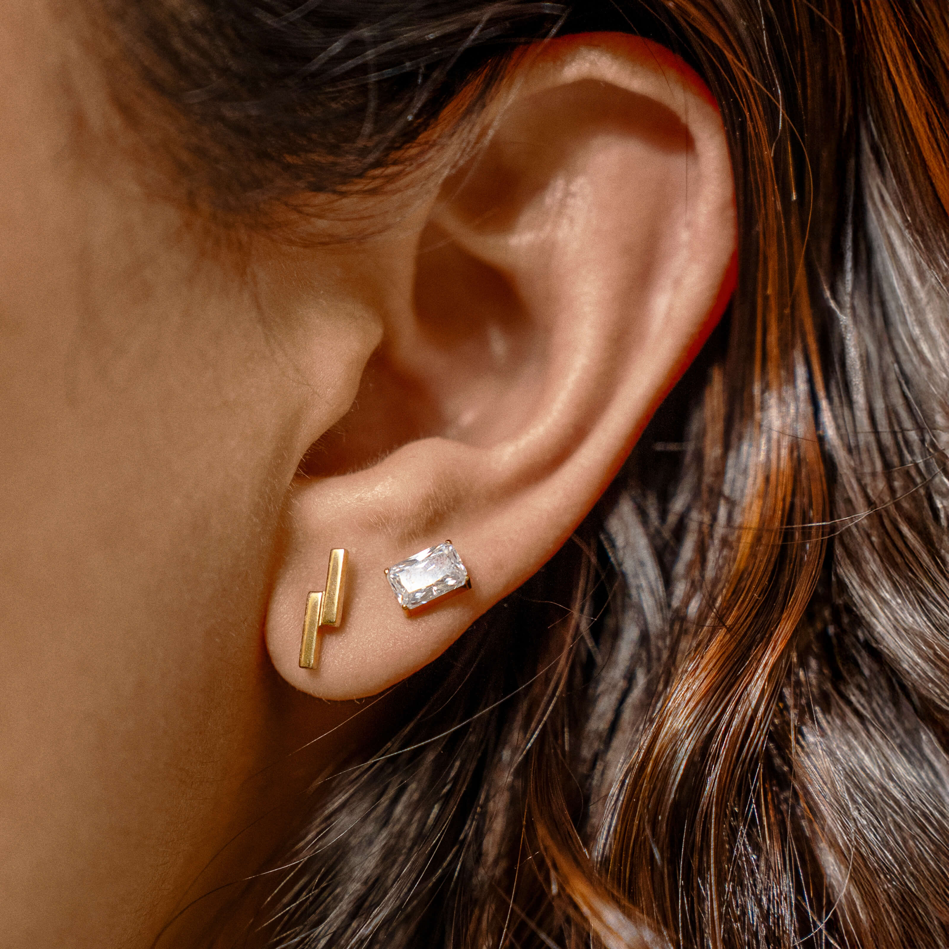 Modernist Nap Earrings Duo - Celestial Crystal Emerald Cut Nap Earrings and Lightning Bar Nap Earrings in Gold on model