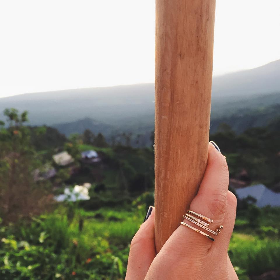 Hand with stacked rings, Bali backdrop