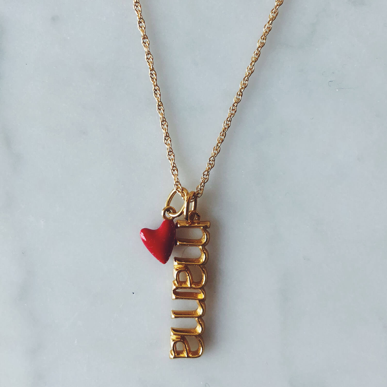 Itty Bitty Red Heart in Gold Vermeil on model
