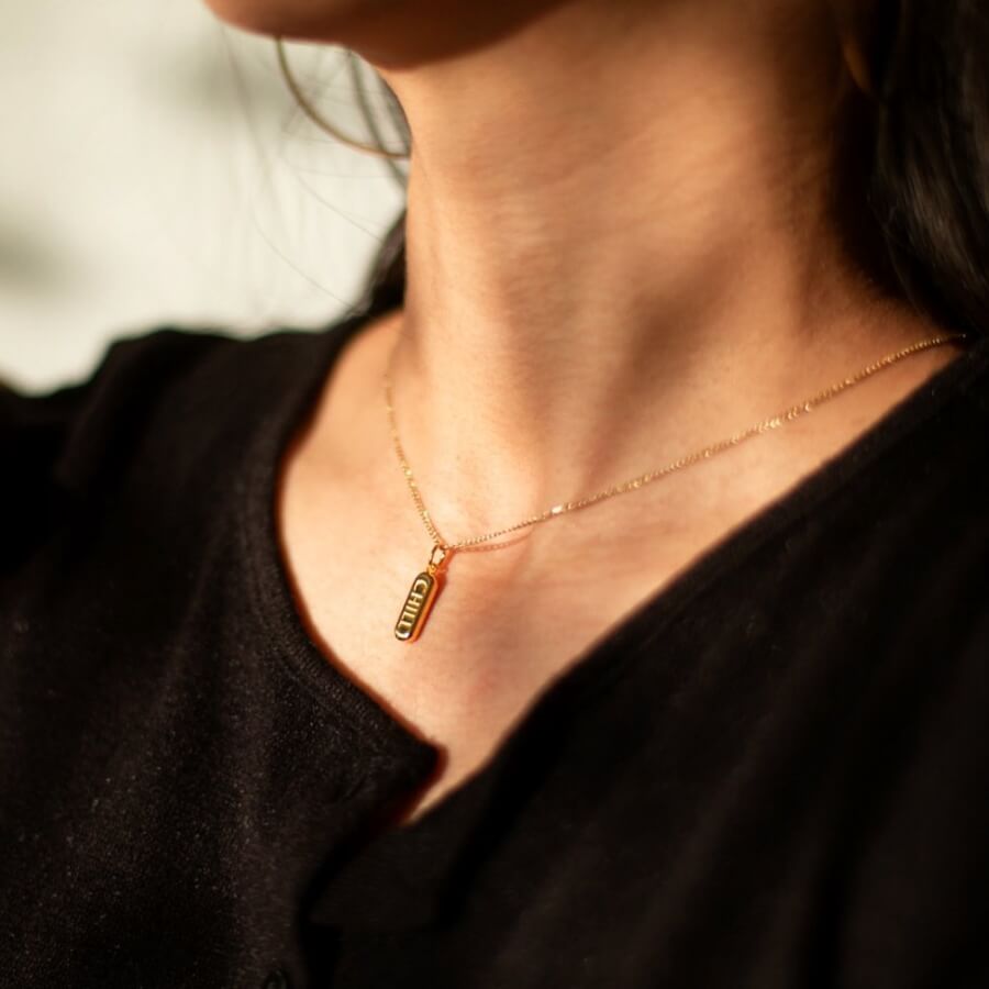 Chill Pill Charm Necklace in Gold on model