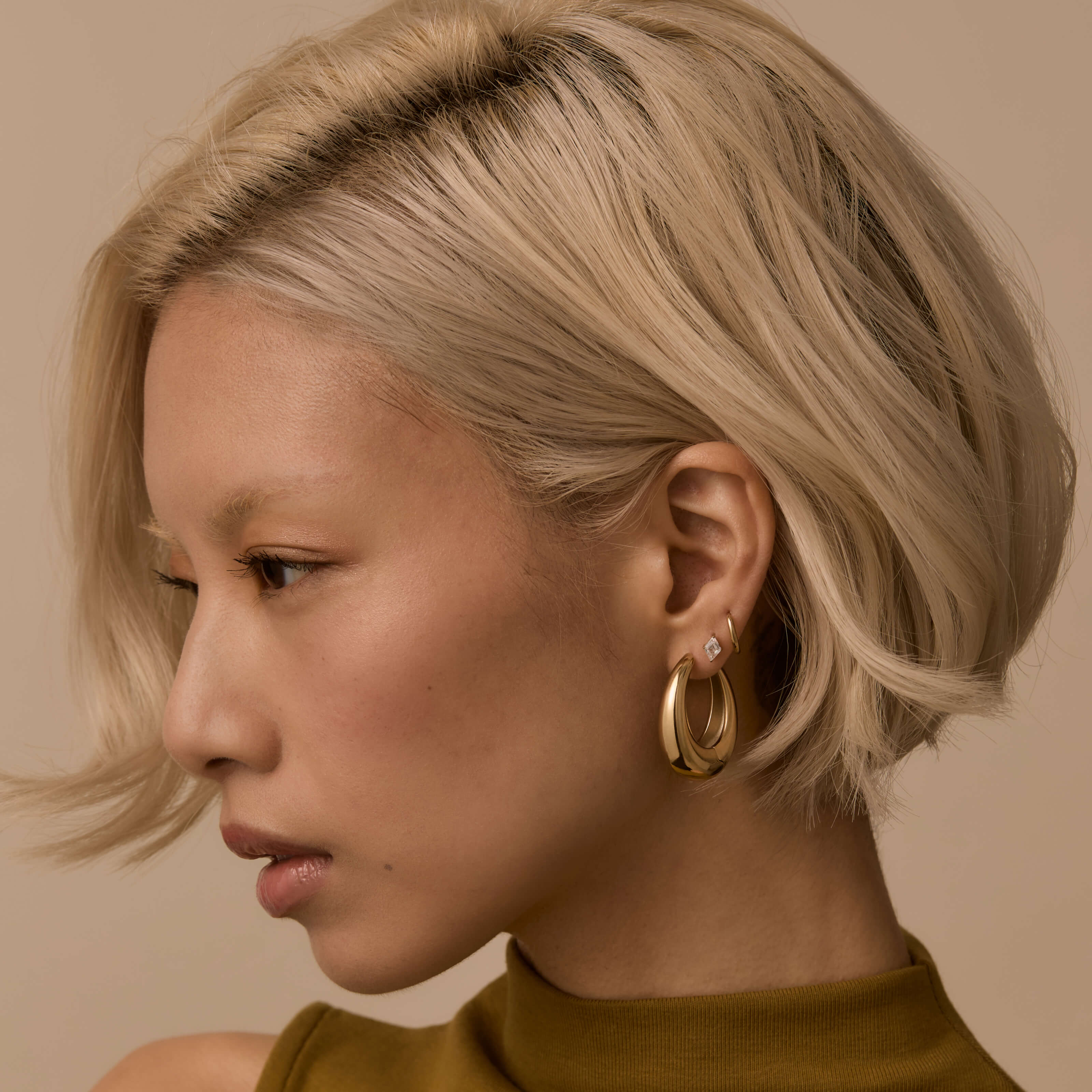 Oeuf Hoops, Classic Huggie Hoops and Celestial Crystal Lozenge Nap Earrings in Gold - on model