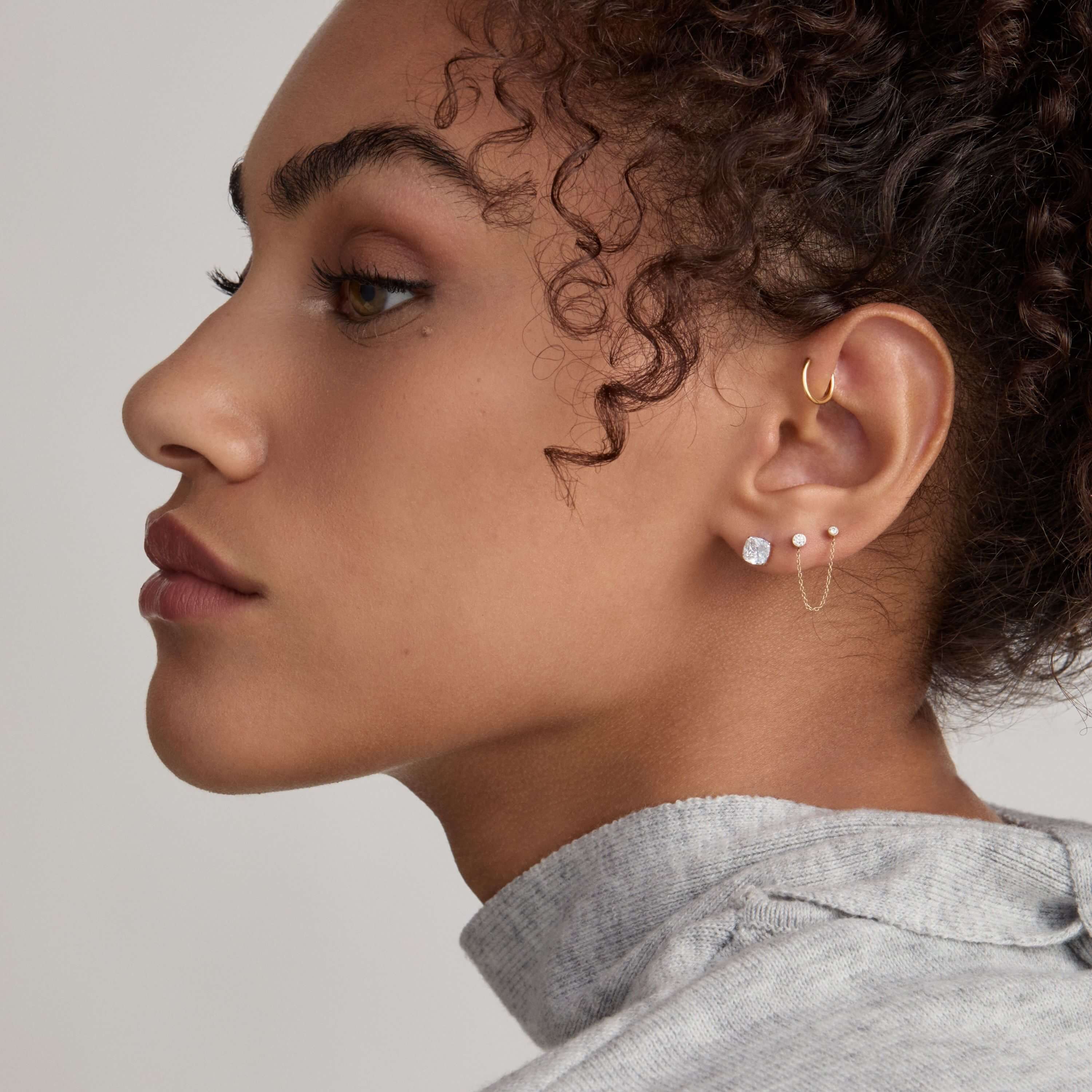 Celestial Crystal Cushion and Celestial Crystal Solitaire Duo Chain Nap Earrings with Classic Cartilage Hoop on Model