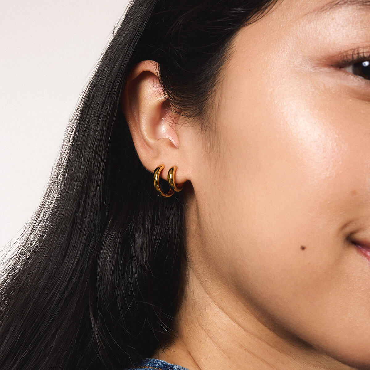 Bold Huggie Hoops in Titanium - Gold and Bold Hoops in Titanium - Gold (On Model)