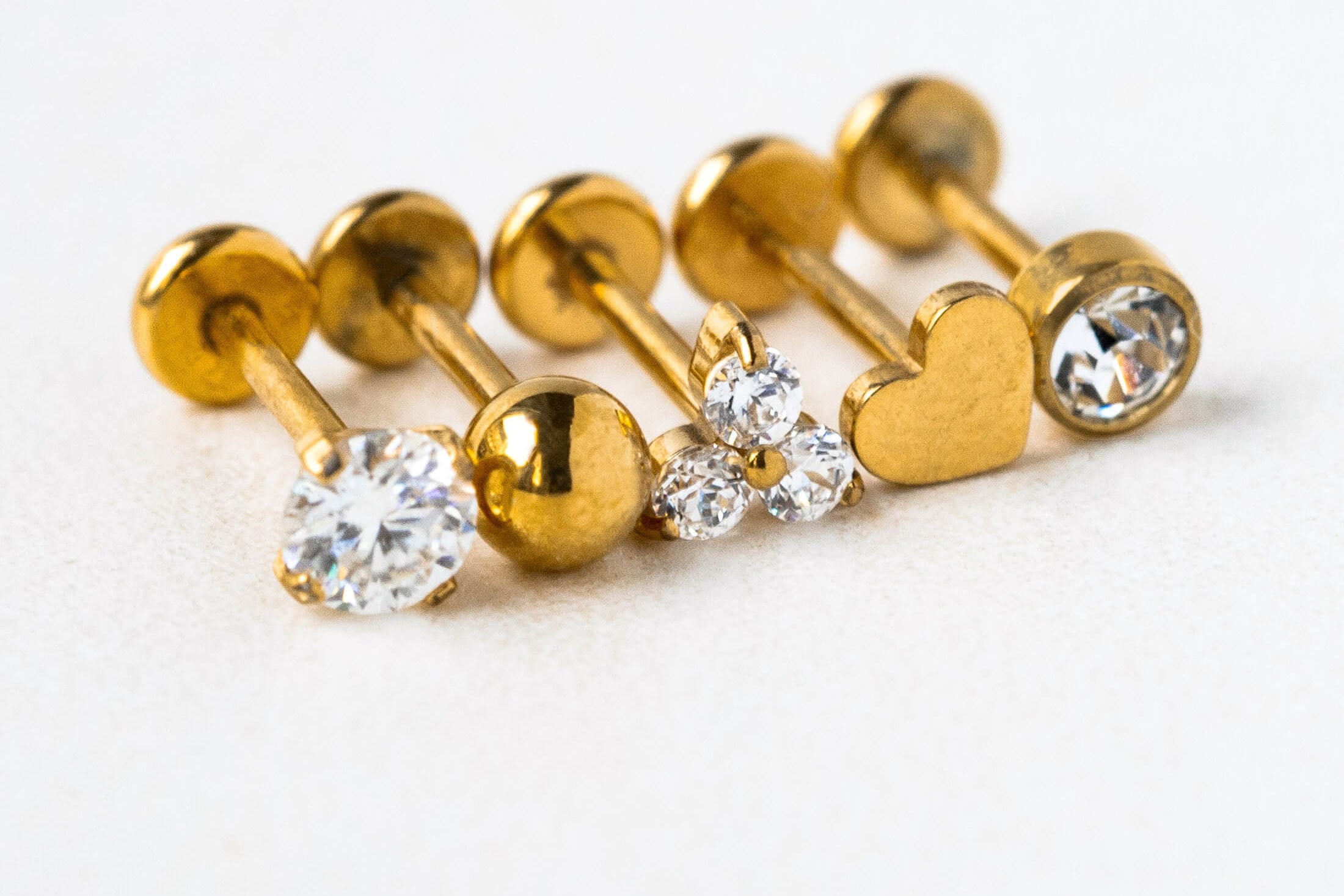 Gold earrings with gemstones on a white background