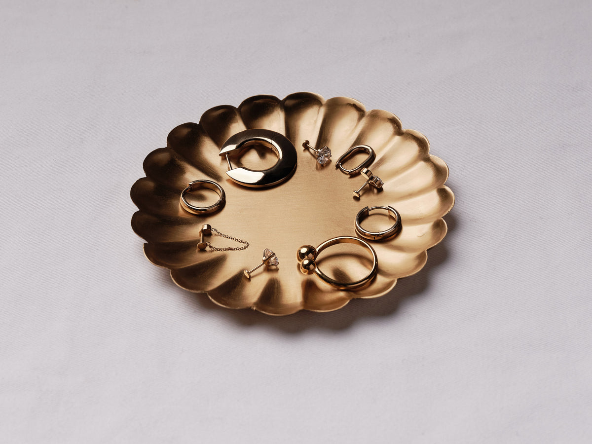 Brass petal tray holding jewelry