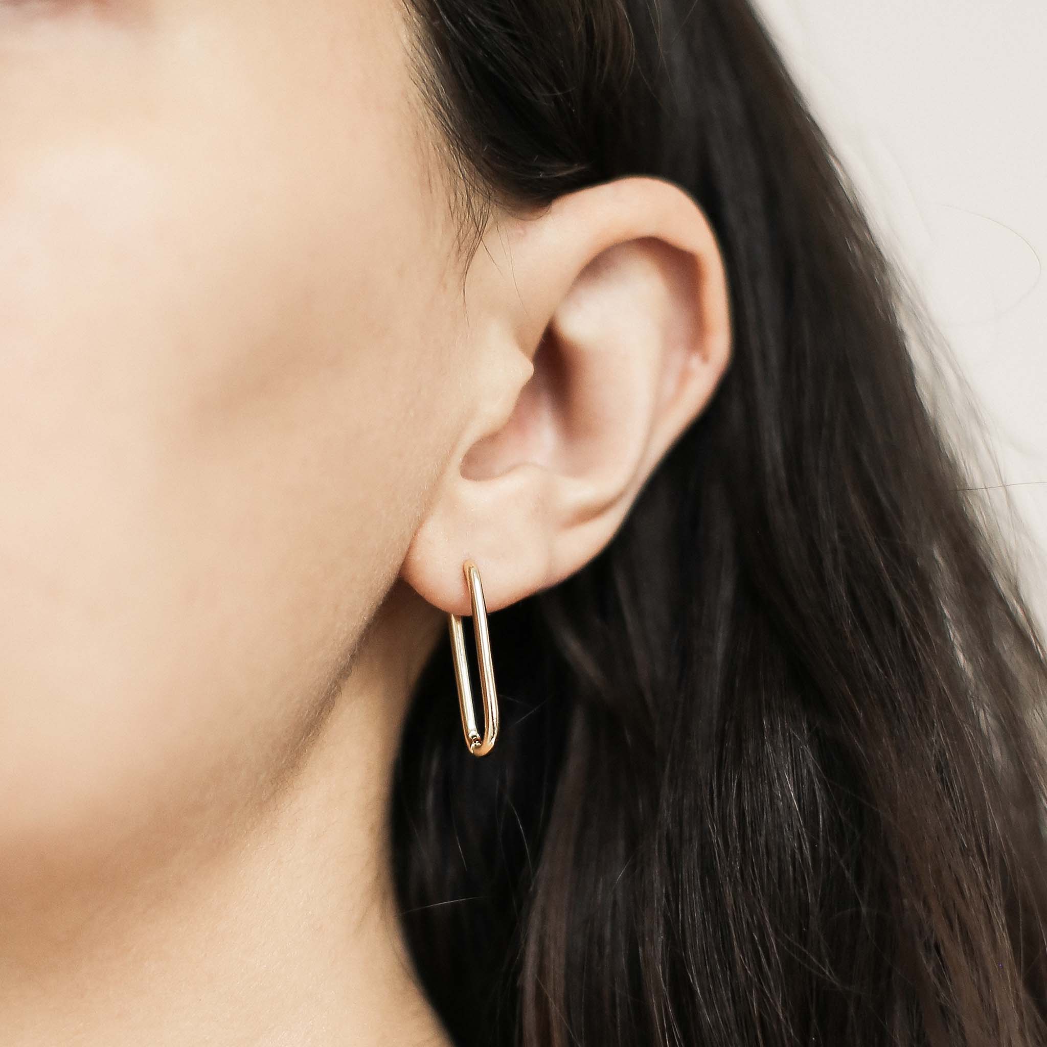 Halo Oval Hoop Earrings in Titanium (Gold) on model