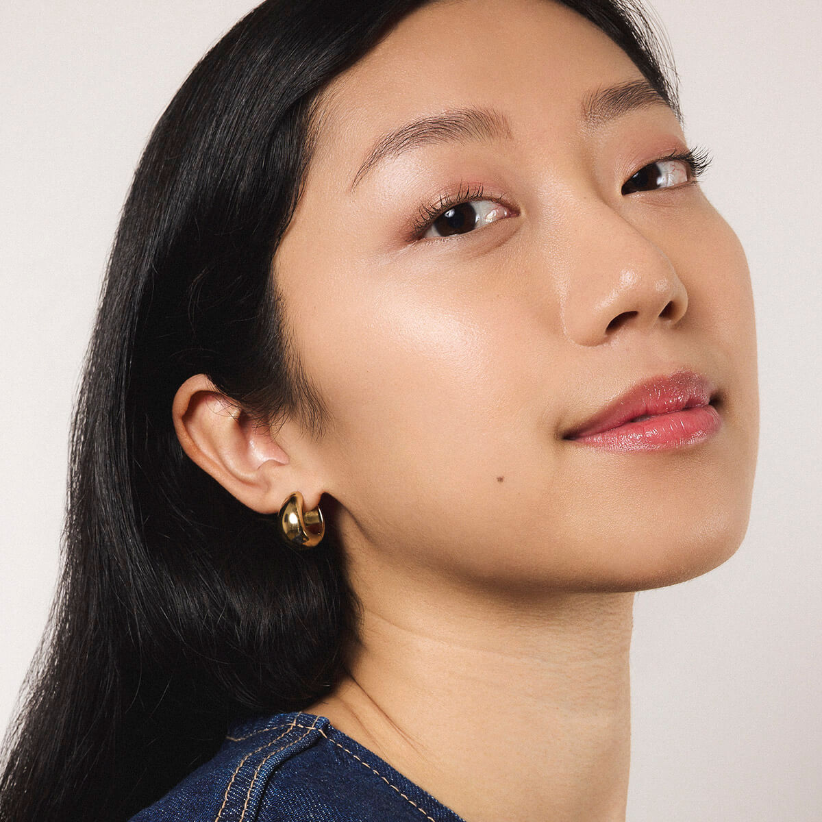 Mini Dewdrop Hoops in Titanium - On Model (Gold