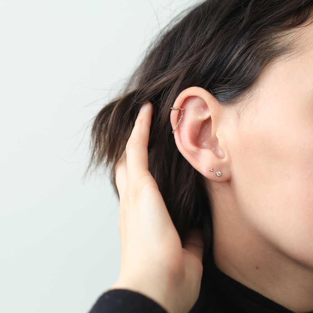 Tiny Trinity Studs in 14k Gold on model