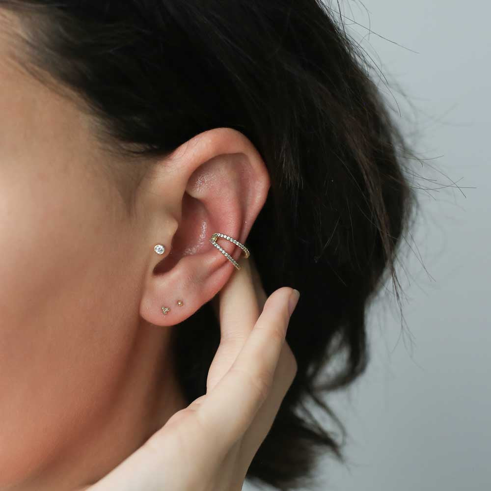 Tiny Trinity Studs in 14k Gold on model