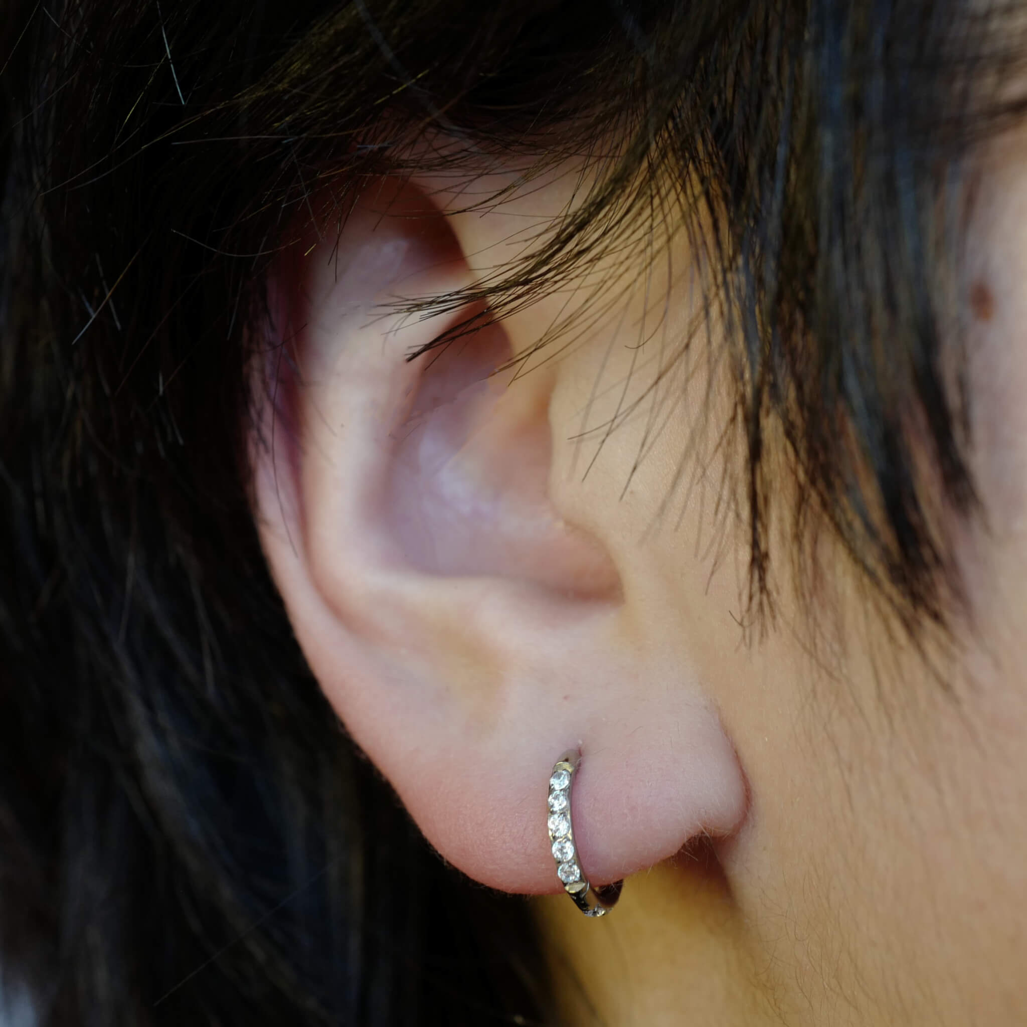 Mini Eternity Hoop Earrings in Titanium (Silver) on model