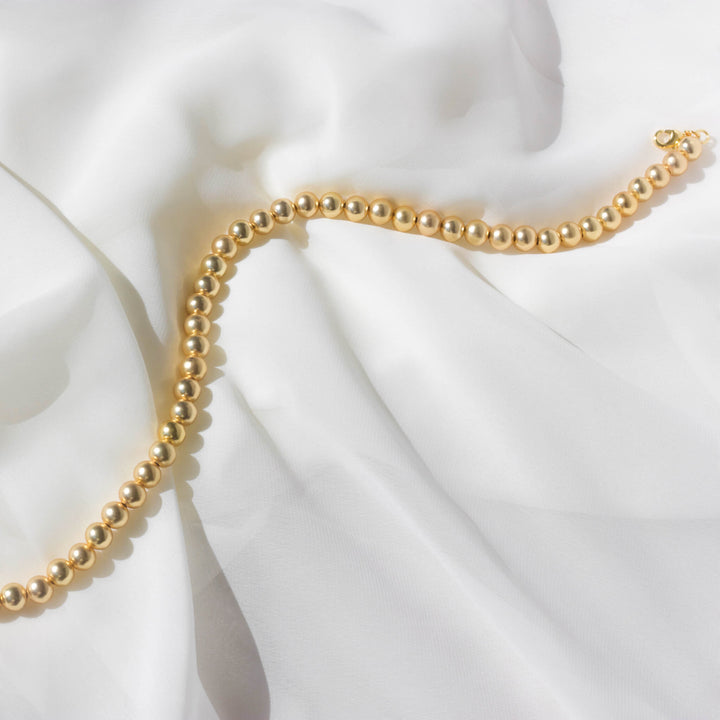 Industrial Pearl Necklace in Gold flat lay