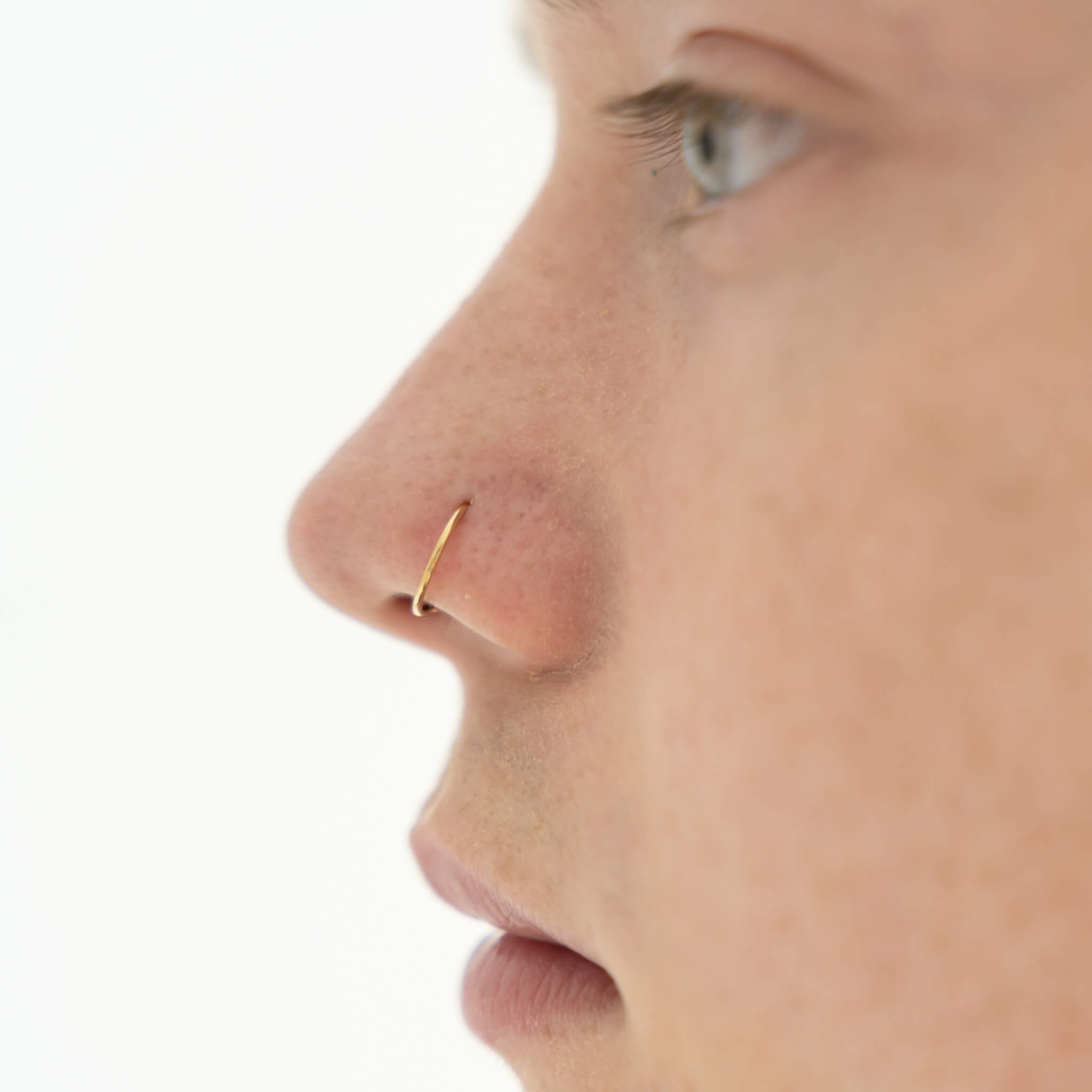 Tiny Secret Nose Hoop Ring in 14k Gold on model